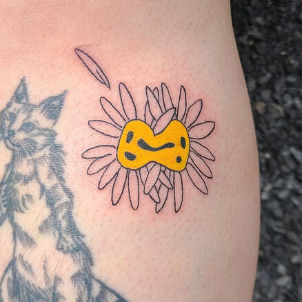 tattoos of mutated daisies with faces blending into each other on their centers.